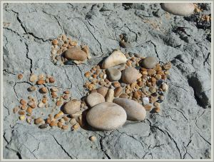 Dried clay on the beach with gravel and pebbles