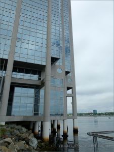Waterside high rise building with barnacle encrusted support piles