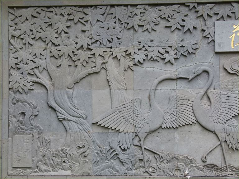 Low relief stone sculpture of cranes