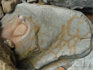Odd beach boulder with iron stains