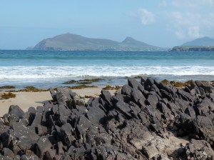 View looking northeast over Smerwick Harbour with Devonian rock outcrop on beach in the foreground