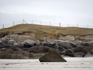 Erosion of the sand dunes on the west side of the tombolo (spit) at Dogs Bay