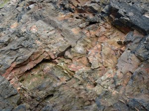 Cliff face with fresh loss of stone indicated by orange markings