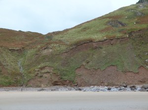 Old land slip area with boulders on the shore at Rhossili