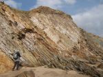 View of cliffs at Clogher Bay with human figure for scale