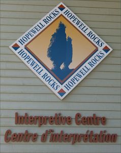 Sign for the Hopewell Rocks Interpretation Centre in New Brunswick, Canada, on the shore of the Bay of Fundy.