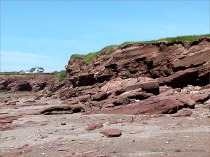 Red Triassic rocks in low cliffs on Waterside Beach in New Brunswick