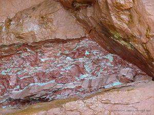 Layer of mottled red and green triassic rock in the cliff at Waterside Beach, New Brunswick.