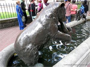Bronze bear eating a salmon in a horse trough in Portland, Oregon
