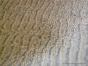 Sand ripples under shallow water at Rhossili Beach