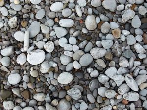 Pebbles on the water's edge at Pwll Du Bay