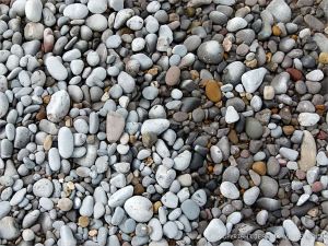 Pebbles on the water's edge at Pwll Du Bay