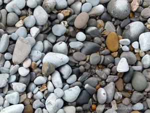 Pebbles on the water's edge at Pwll Du Bay