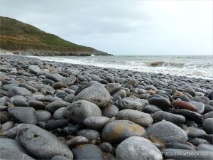 Pebbles on the water's edge at Pwll Du Bay