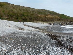 Two streams of water running from the base of shingle banks into the sea