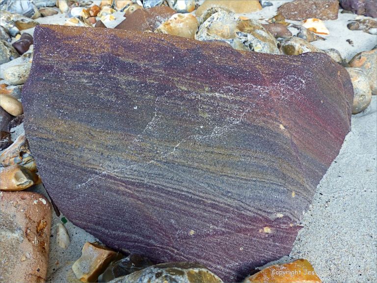 Beach boulder on the north side of Redend Point in Studland Bay, Dorset, England.