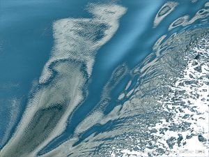 Seafoam pattern on the swell of a bow wave with micro-ripples from the engines of the passing ferry on the Northumberland Strait