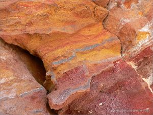 Colourful rock at Worbarrow Bay in Dorset UK