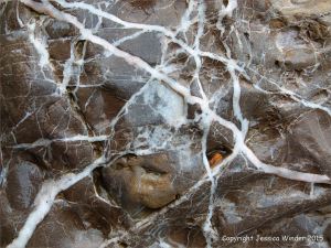 Interesting patterns with white veins in rip-rap at Seaton in Devon, England