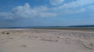 View across the sand-covered pebble bar at Whiteford Point