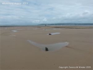 View looking towards the lighthouse at Whiteford on the Gower Peninsula showing the area mostly covered by sand