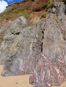 Carboniferous limestone cliff with calcite veins at Threecliff Bay, Gower