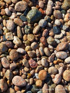 Colourful and patterned pebbles of igneous rocks