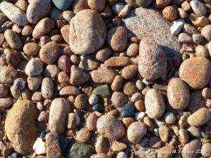 Colourful and patterned pebbles of igneous rocks