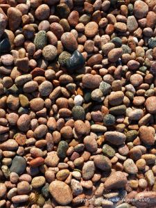 Colourful and patterned pebbles of igneous rocks