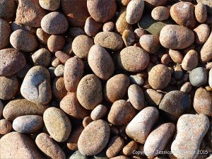 Colourful and patterned pebbles of igneous rocks
