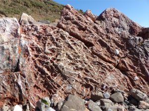 Rock texture and pattern in red haematite in Carboniferous limestone at Worm's Head