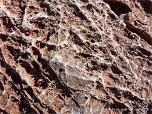 Rock texture and pattern in red haematite in Carboniferous limestone at Worm's Head