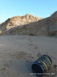 Black plastic oil drum washed ashore