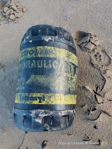 Black plastic oil drum washed ashore