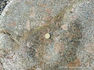 Close-up detail of L'Eree Granite crystals in rock on the Channel Island of Guernsey