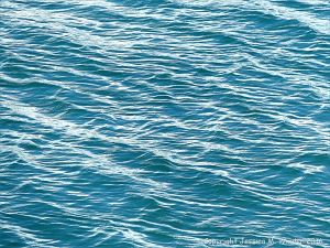 Calm blue-green sea gently rippled by the wind