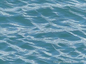 Calm blue-green sea gently rippled by the wind
