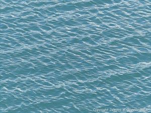 Calm blue-green sea gently rippled by the wind