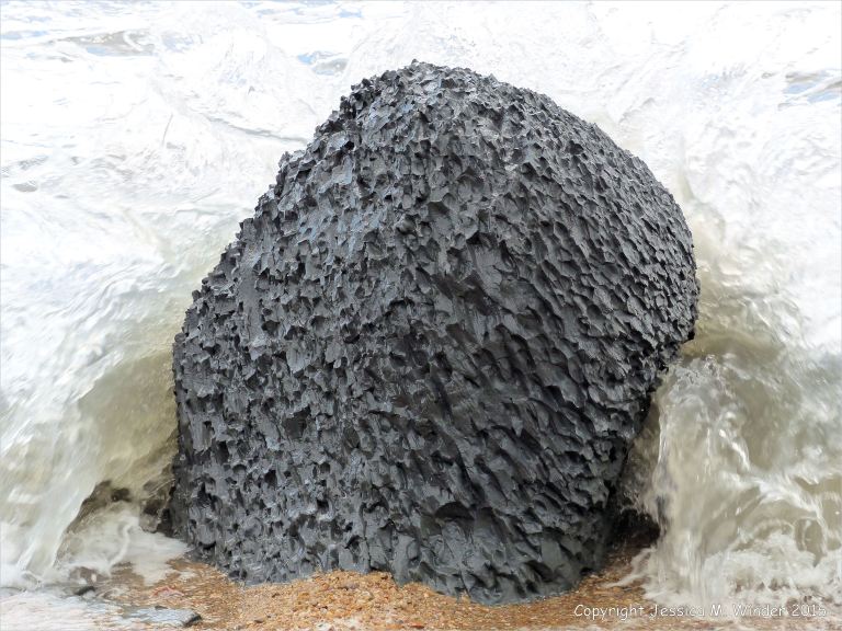 Beach boulders at Charmouth on the World Heritage Jurassic Coast in Dorset, England.