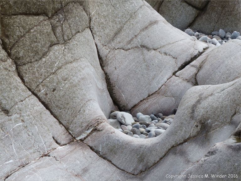 Water-worn limestone rock layers on the Worms Head Causeway in Gower, South Wales.