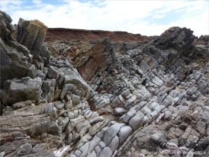 Water-worn limestone rock layers on the Worms Head Causeway in Gower, South Wales.