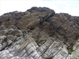 Water-worn limestone rock layers on the Worms Head Causeway in Gower, South Wales.