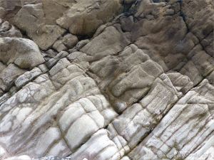 Water-worn limestone rock layers on the Worms Head Causeway in Gower, South Wales.