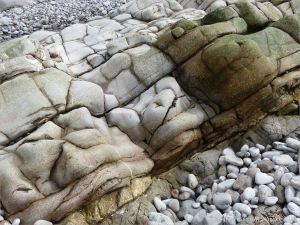 Water-worn limestone rock layers on the Worms Head Causeway in Gower, South Wales.