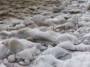 Weathered limestone rock layers on the Worms Head Causeway in Gower, South Wales.