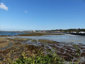 View looking over rocks towards Fort Grey at Rocquaine Bay on Guernsey