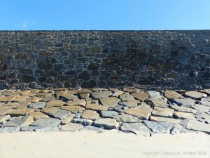 Stone sea wall at Rocquaine Bay