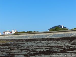 Sea wall of stone and concrete at the northern end of Rocquaine Bay