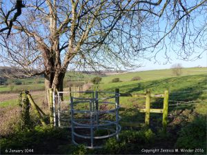 Rural view with stile in winter on the Cerne Valley Trail, Dorset, England.
