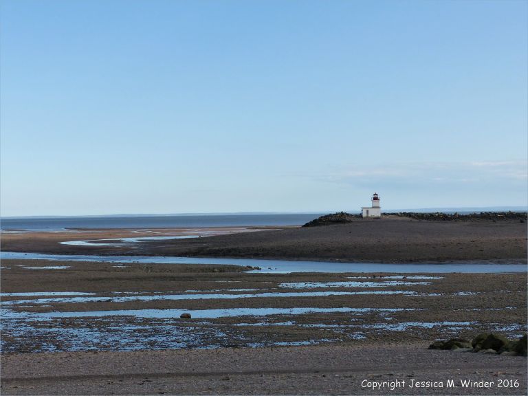 Beachscape with lighthouse at Parrsboro, Nova Scotia, Canada.